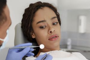 Young woman experiencing anxiety at orthodontics appointment