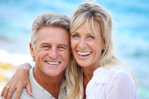 Smiling mature couple at the beach